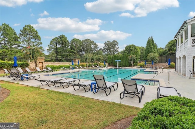 view of pool with a lawn and a patio area