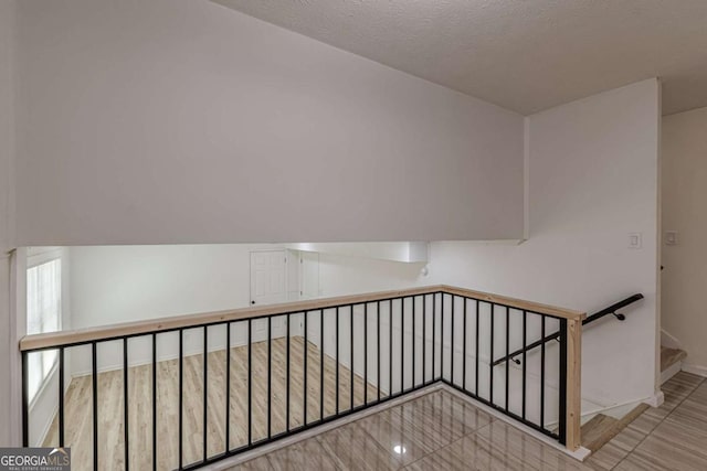 staircase with a textured ceiling