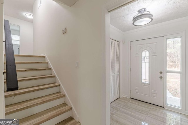 foyer featuring a textured ceiling