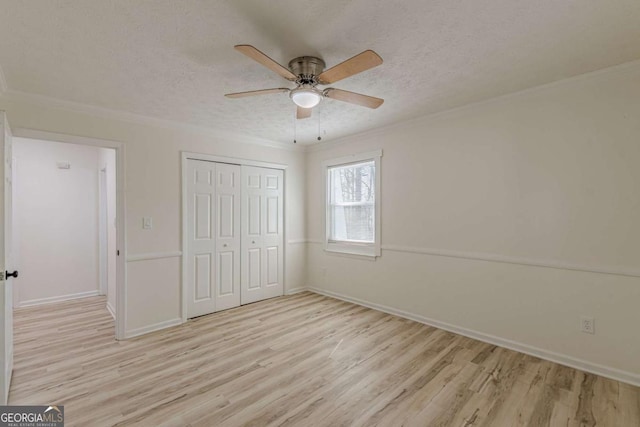 unfurnished bedroom with ornamental molding, a textured ceiling, and light hardwood / wood-style floors