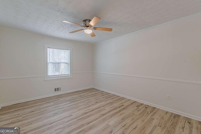 spare room with crown molding, ceiling fan, a textured ceiling, and light hardwood / wood-style flooring