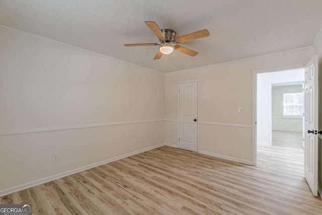 unfurnished room with crown molding, ceiling fan, a textured ceiling, and light wood-type flooring