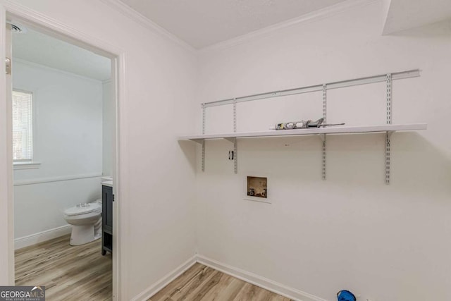 laundry room featuring ornamental molding, light hardwood / wood-style floors, and hookup for a washing machine