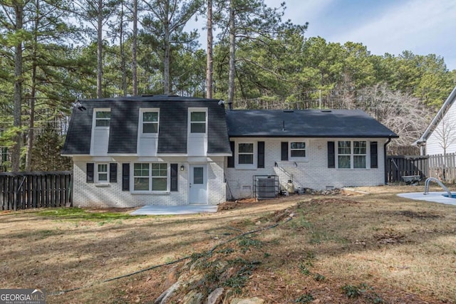 view of front of home featuring central AC, a front yard, and a patio area