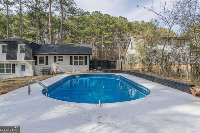 view of pool with central AC unit