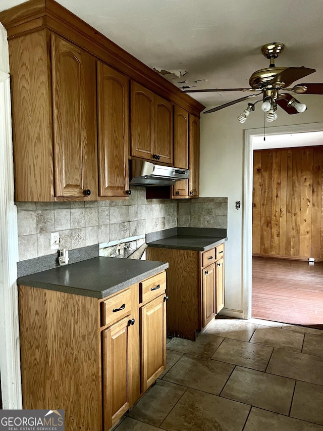 kitchen featuring ceiling fan and backsplash