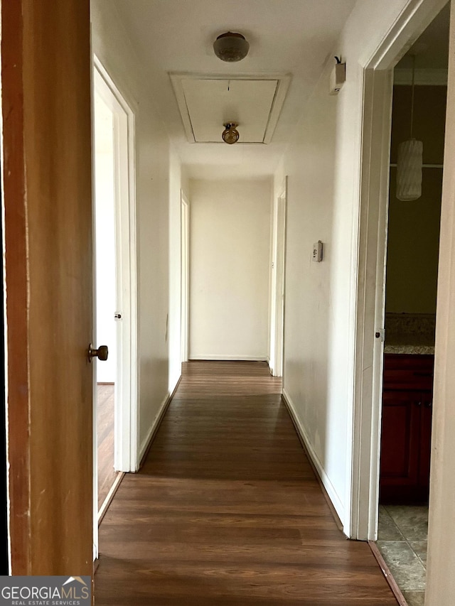 corridor with dark hardwood / wood-style flooring