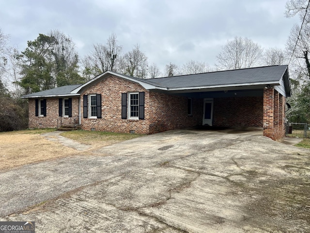 ranch-style home featuring a carport