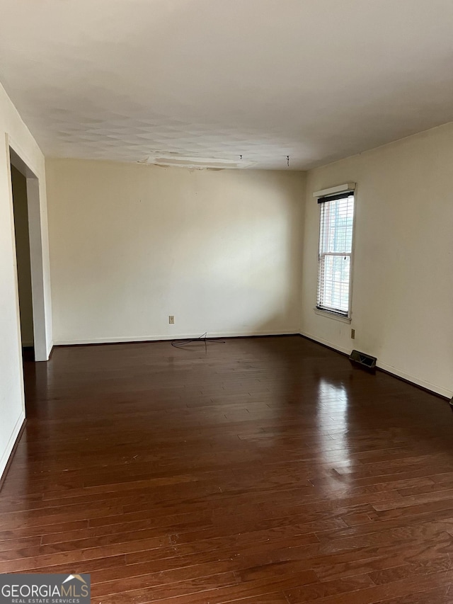 unfurnished room featuring dark hardwood / wood-style flooring