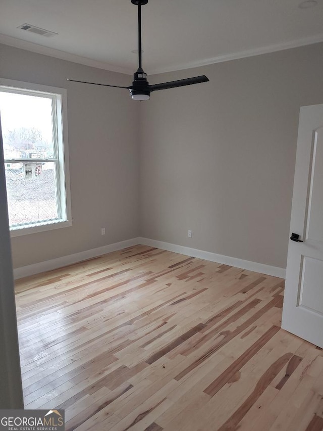 unfurnished room featuring crown molding, ceiling fan, and light hardwood / wood-style floors