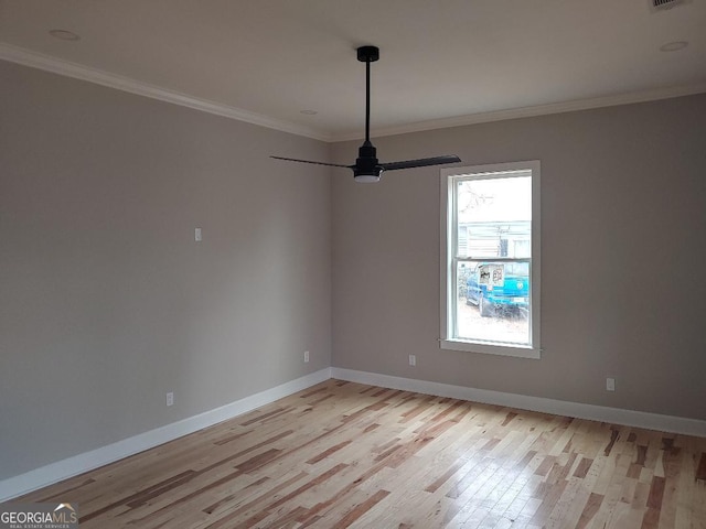 empty room featuring ceiling fan, ornamental molding, and light hardwood / wood-style flooring