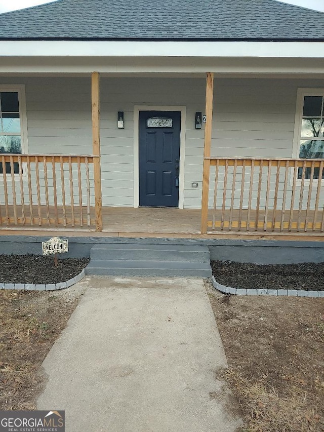 view of exterior entry featuring a porch