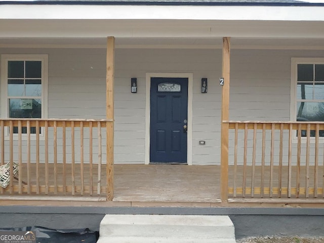 entrance to property featuring a porch