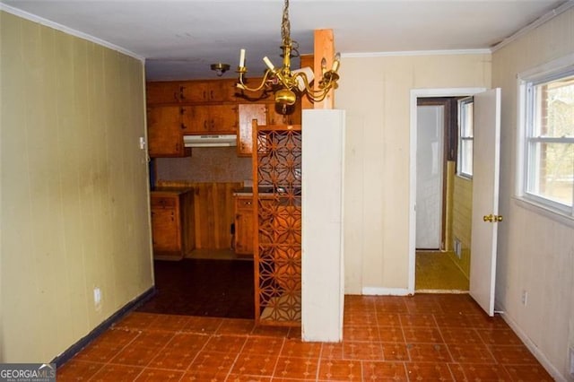 kitchen featuring ornamental molding and a notable chandelier