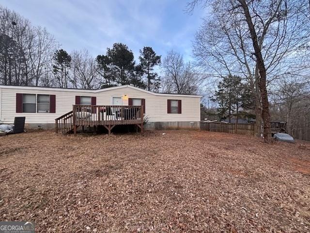 back of property with a wooden deck