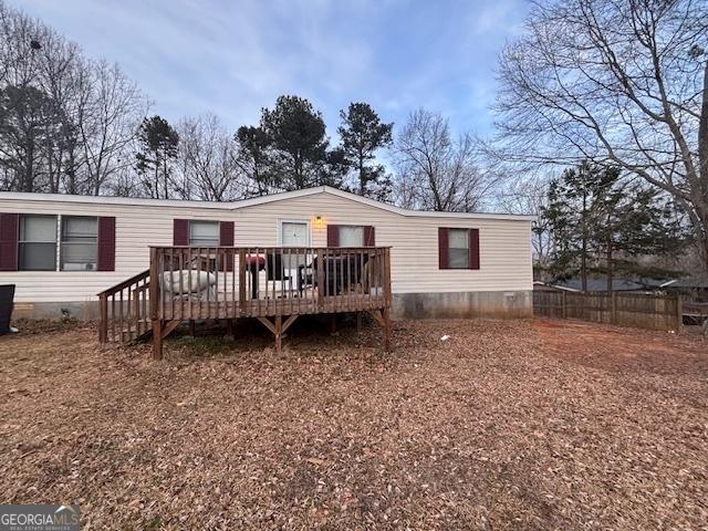 back of house featuring a deck