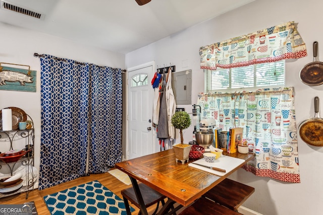 dining area featuring hardwood / wood-style flooring and electric panel