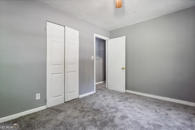 unfurnished bedroom with carpet floors, ceiling fan, and a closet