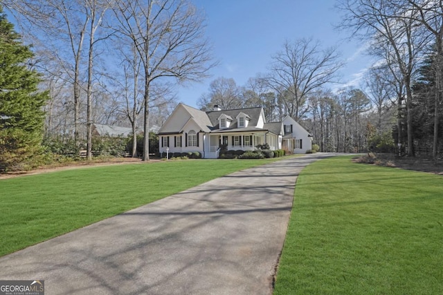 cape cod-style house with a porch and a front lawn