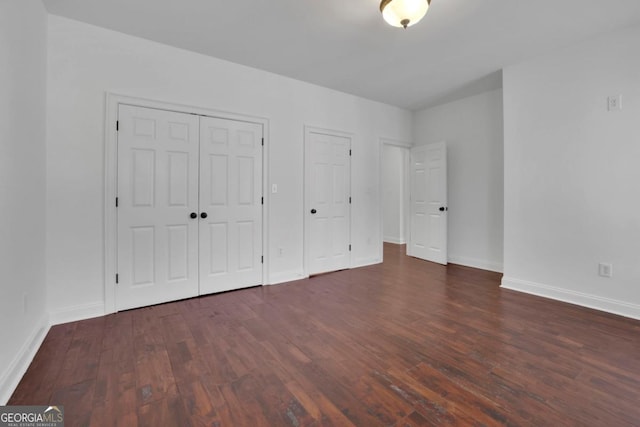 unfurnished bedroom featuring dark hardwood / wood-style floors