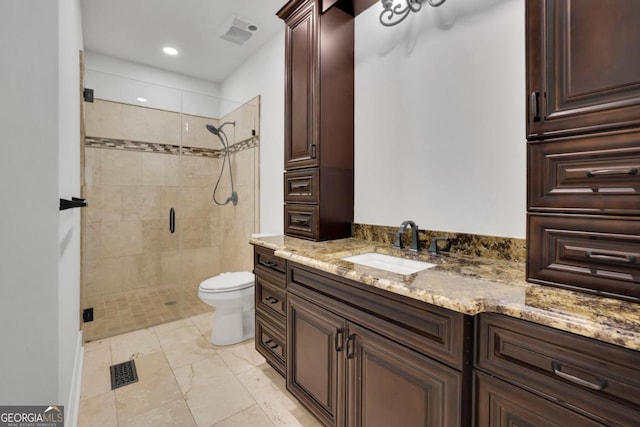 bathroom featuring vanity, toilet, and an enclosed shower