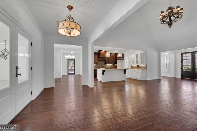 foyer entrance with an inviting chandelier and french doors