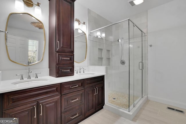 bathroom featuring vanity and a shower with shower door