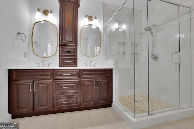 bathroom featuring vanity and a shower with shower door