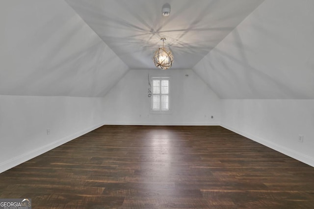 bonus room with lofted ceiling and dark wood-type flooring