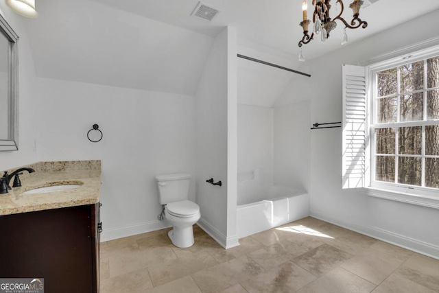 bathroom with lofted ceiling, plenty of natural light, and vanity