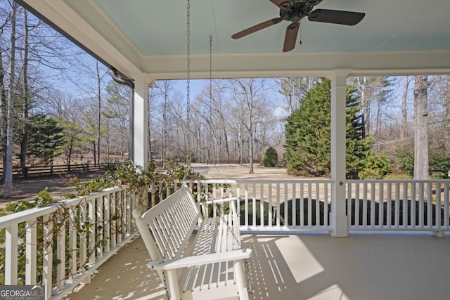 sunroom featuring a water view