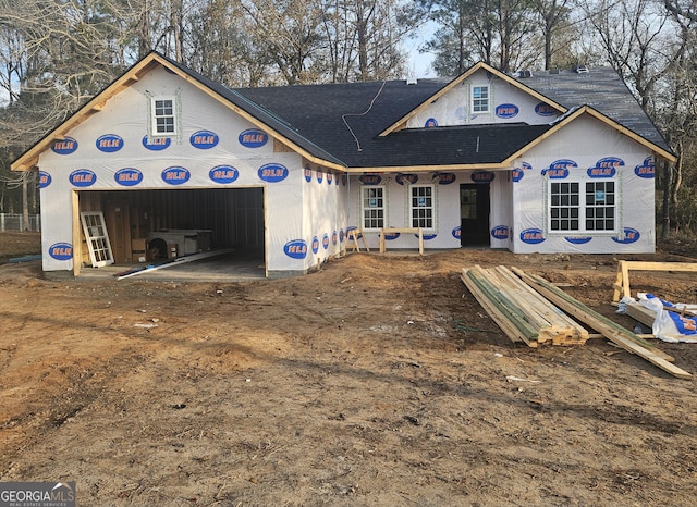 unfinished property featuring a garage