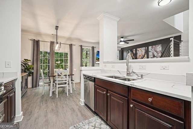 kitchen with sink, light stone counters, ornamental molding, decorative light fixtures, and stainless steel dishwasher