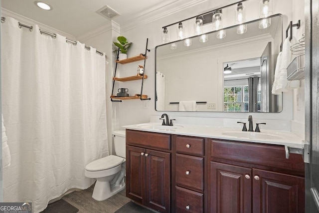 bathroom with crown molding, vanity, toilet, and hardwood / wood-style flooring