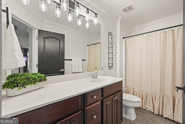 bathroom with vanity, hardwood / wood-style floors, ornamental molding, and toilet