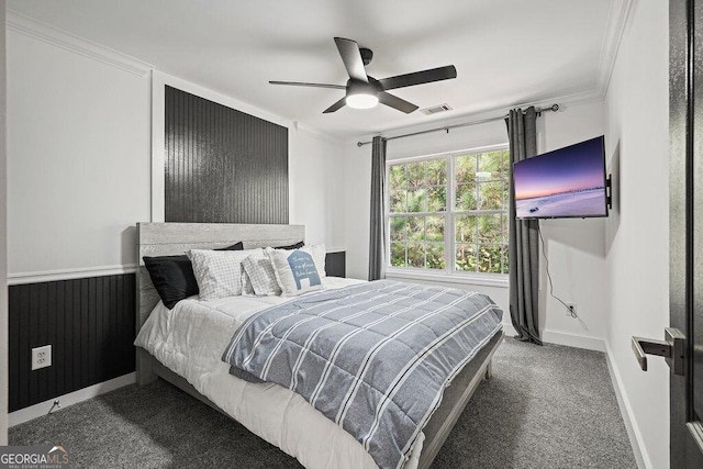 bedroom featuring crown molding, ceiling fan, and dark carpet