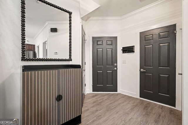 entrance foyer with crown molding and hardwood / wood-style flooring