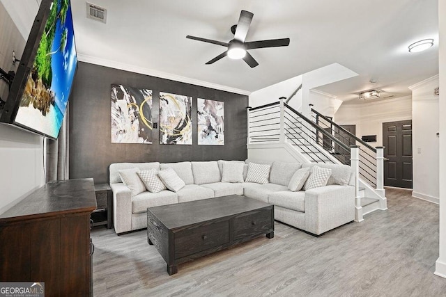 living room featuring crown molding, ceiling fan, and light hardwood / wood-style flooring