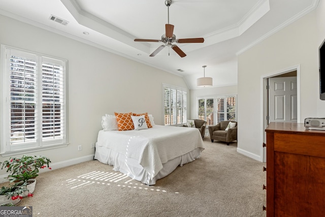 bedroom with a raised ceiling, ornamental molding, light colored carpet, and ceiling fan