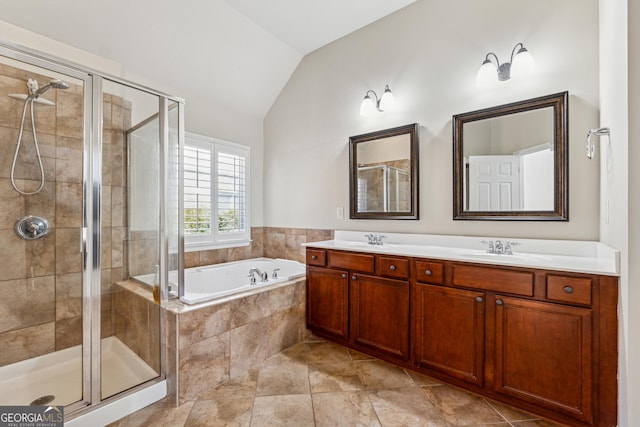 bathroom with vanity, lofted ceiling, and separate shower and tub