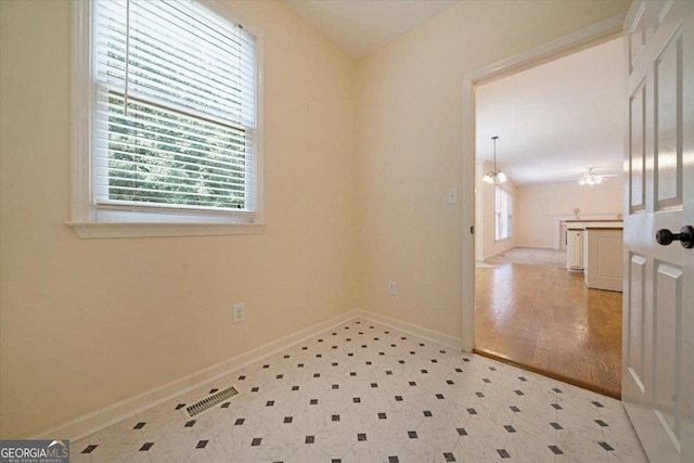 unfurnished room with light floors and baseboards