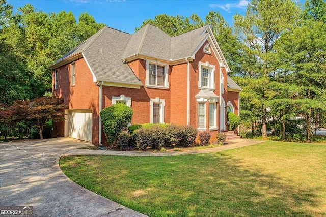 view of front of home with a garage and a front yard