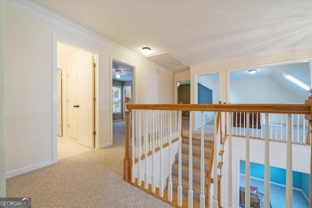 hallway featuring light carpet, ornamental molding, and an upstairs landing