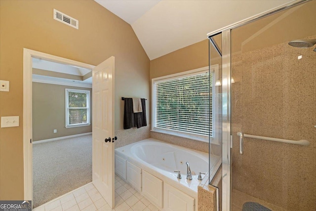 bathroom with lofted ceiling, independent shower and bath, and tile patterned flooring