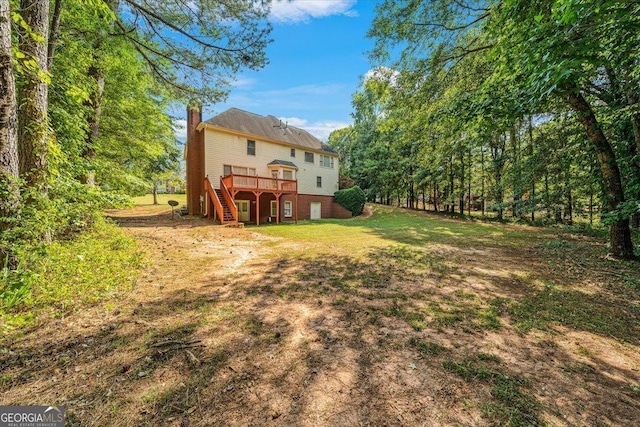 view of yard featuring stairs and a wooden deck