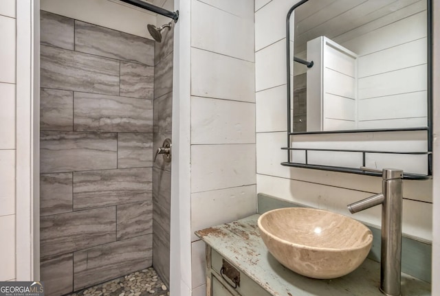 bathroom featuring a tile shower and sink