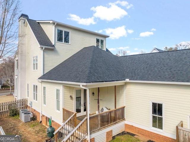 back of house featuring central AC and covered porch