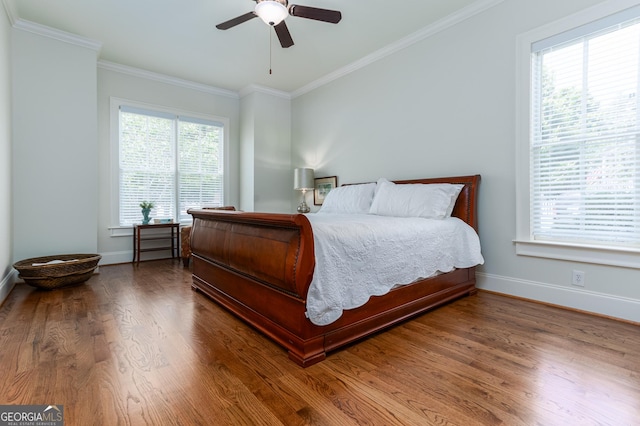 bedroom with hardwood / wood-style flooring, ceiling fan, and crown molding