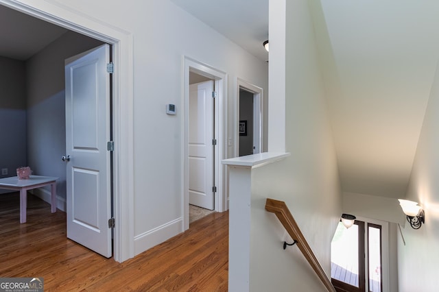 hallway with hardwood / wood-style flooring