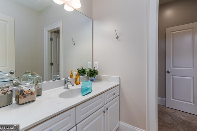 bathroom with tile patterned flooring, vanity, and baseboards
